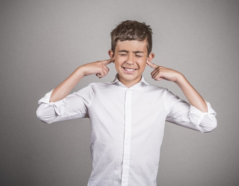 Closeup portrait unhappy, annoyed young man plugging closing ears with fingers disgusted ignoring something not wanting to hear someone side story isolated grey background. Human emotion body language-1- (1)