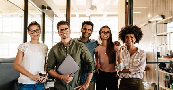 Happy employees standing in an office