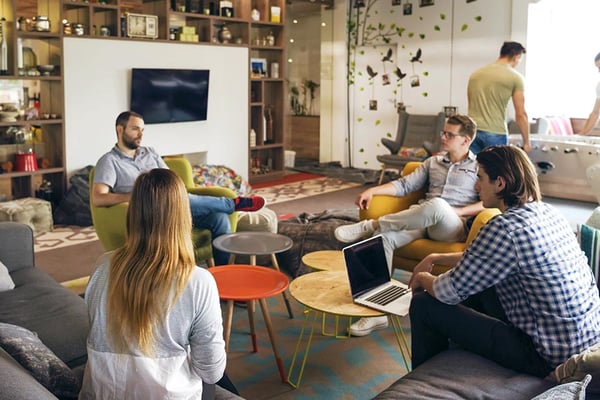 Employees sitting in a circle having a meeting